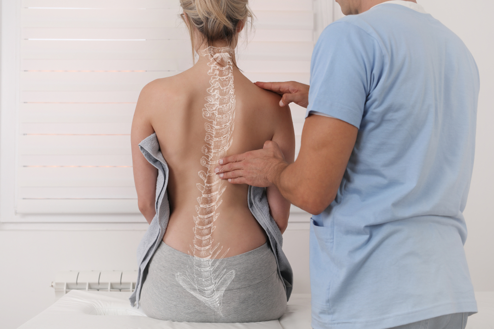 A patient discusses scoliosis surgery with her doctor