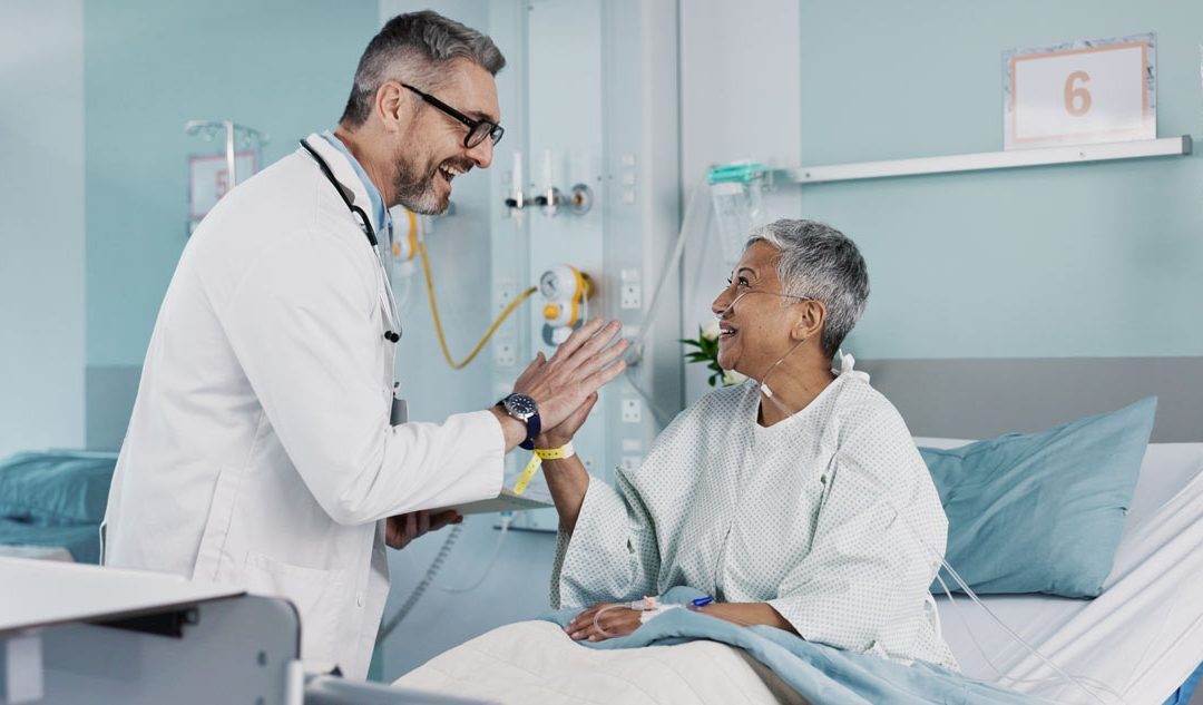 Back surgery patient smiles while high-fiving doctor as she recovers from back surgery